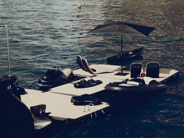 Black Rock Yacht Photos Pics Custom 77 floating platform with chairs and umbrella on water, 2008 model.