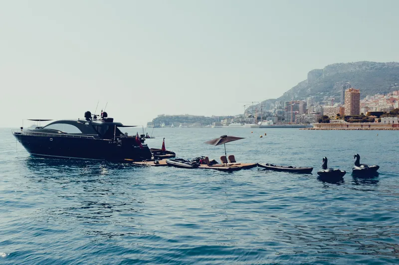 Black Rock Yacht Photos Pics Luxury yacht Custom 77 (2008) anchored near scenic coastal cityscape.