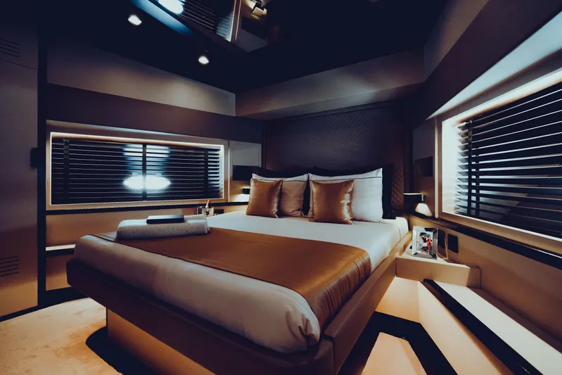Black Rock Yacht Photos Pics Luxurious bedroom interior with modern design, featuring a cozy bed and ambient lighting.