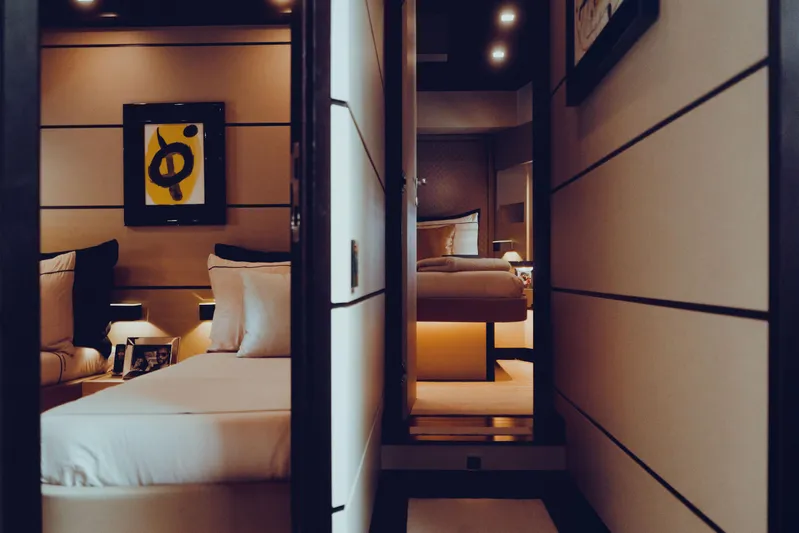 Black Rock Yacht Photos Pics Luxurious yacht interior with modern decor, featuring cozy beds and stylish artwork, Custom 77, 2008.