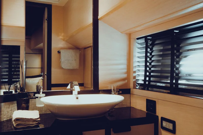 Black Rock Yacht Photos Pics Luxurious bathroom with modern sink, sleek black countertop, and stylish blinds. Custom 77, 2008.