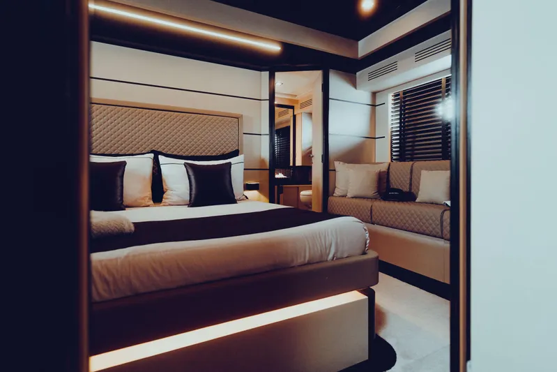 Black Rock Yacht Photos Pics Luxurious bedroom interior in Custom 77 yacht, 2008 model, featuring modern design and ambient lighting.