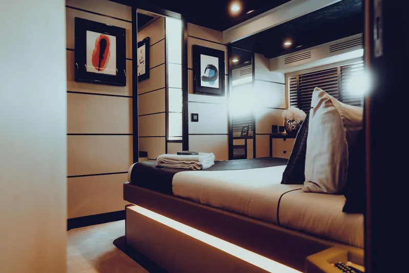Black Rock Yacht Photos Pics Luxurious modern bedroom with ambient lighting, artwork, and sleek design elements.