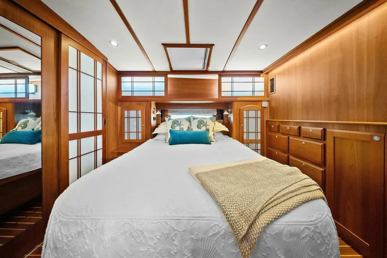 Rowe Boat Yacht Photos Pics Luxurious bedroom interior of 2018 Sabre 48 Salon Express yacht with elegant wood paneling.