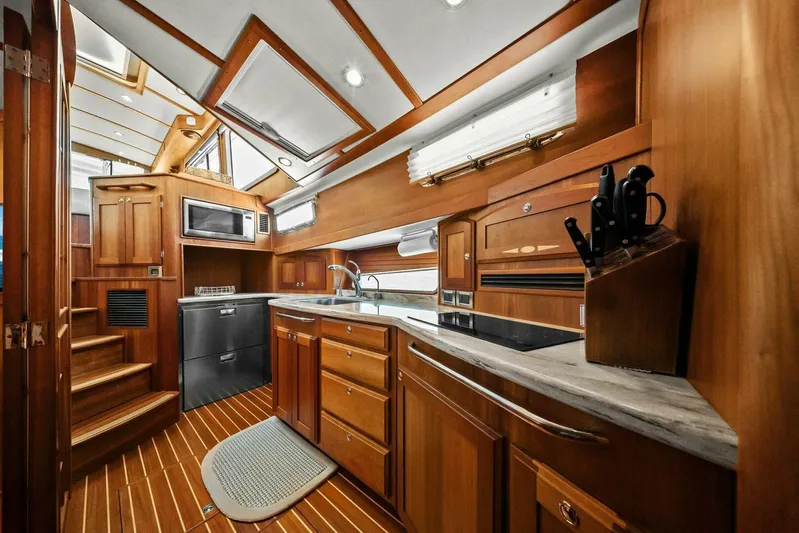 Rowe Boat Yacht Photos Pics Luxurious 2018 Sabre 48 Salon Express yacht interior with modern kitchen and wooden cabinetry.