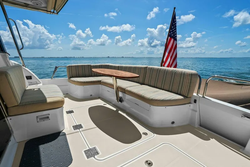 Rowe Boat Yacht Photos Pics 2018 Sabre 48 Salon Express yacht deck with seating, table, and ocean view.