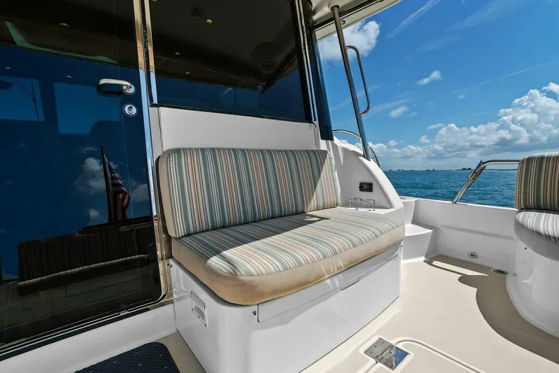 Rowe Boat Yacht Photos Pics 2018 Sabre 48 Salon Express yacht interior with striped seating, ocean view, and blue sky.