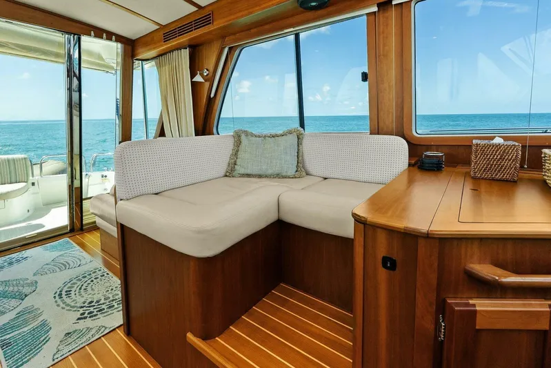 Rowe Boat Yacht Photos Pics 2018 Sabre 48 Salon Express interior with ocean view, featuring elegant wood and cozy seating.