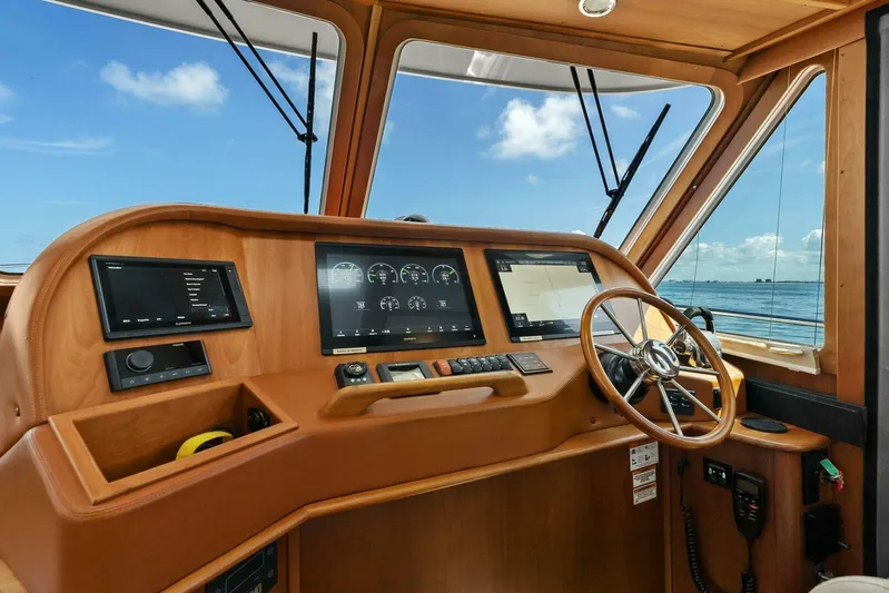 Rowe Boat Yacht Photos Pics 2018 Sabre 48 Salon Express helm with navigation screens and wooden steering wheel.