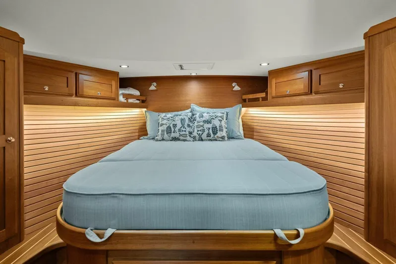 Rowe Boat Yacht Photos Pics Luxurious cabin interior of 2018 Sabre 48 Salon Express with cozy bed and wooden accents.