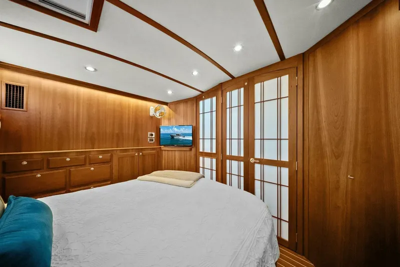 Rowe Boat Yacht Photos Pics Luxurious interior of 2018 Sabre 48 Salon Express yacht with wood paneling and cozy bedding.