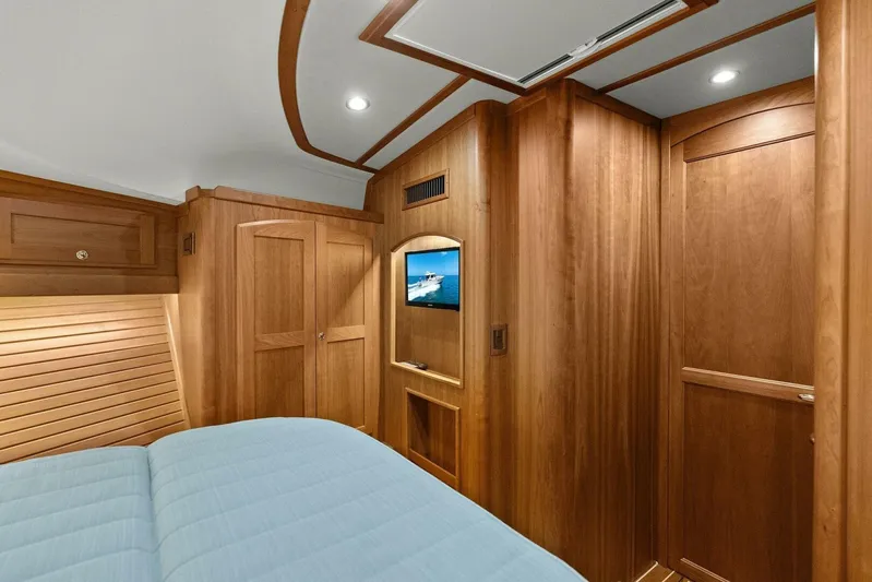 Rowe Boat Yacht Photos Pics Interior of 2018 Sabre 48 Salon Express yacht with wood paneling and a mounted TV.