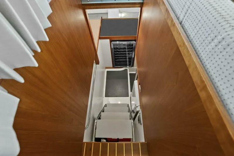 Rowe Boat Yacht Photos Pics Interior stairs of 2018 Sabre 48 Salon Express yacht, featuring wooden paneling and modern design.