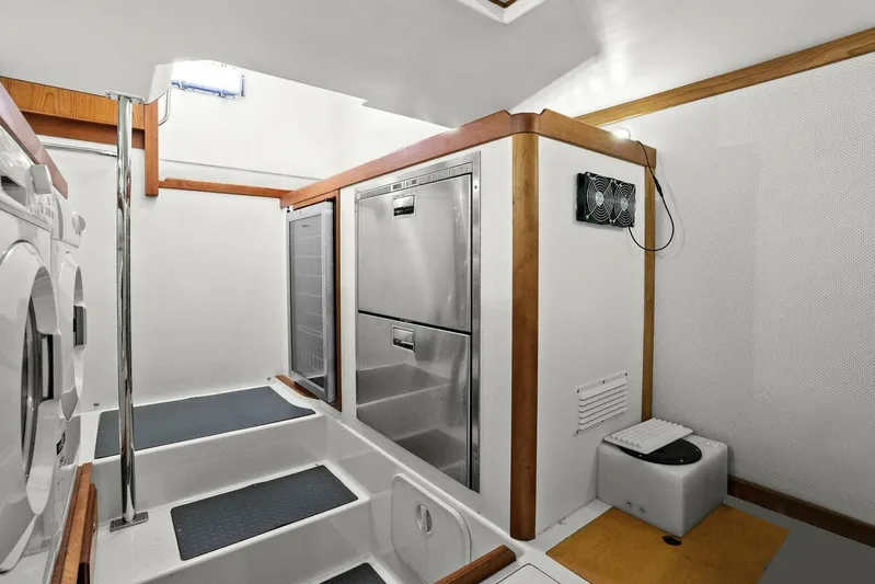 Rowe Boat Yacht Photos Pics Laundry area in 2018 Sabre 48 Salon Express yacht with washer, dryer, and storage.