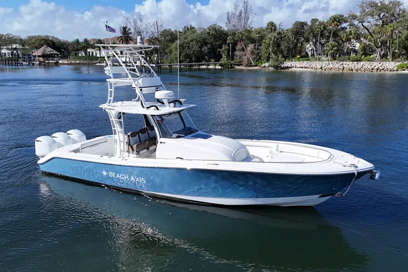  Yacht Photos Pics 2017 Edgewater 368CC boat on calm water, featuring a sleek blue and white design.