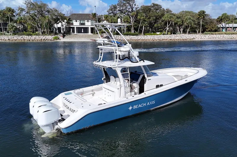  Yacht Photos Pics 2017 Edgewater 368CC boat cruising on a calm river near a scenic shoreline.