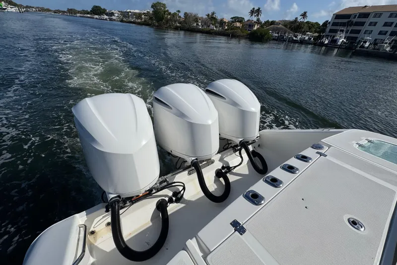 Yacht Photos Pics 2017 Edgewater 368CC boat with triple outboard engines cruising on a scenic waterway.