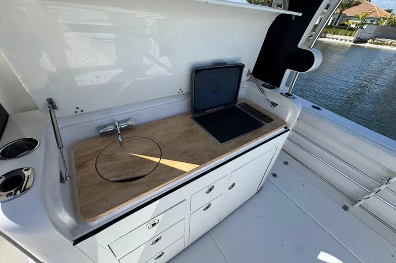  Yacht Photos Pics 2017 Edgewater 368CC boat kitchenette with sink, grill, and storage drawers.