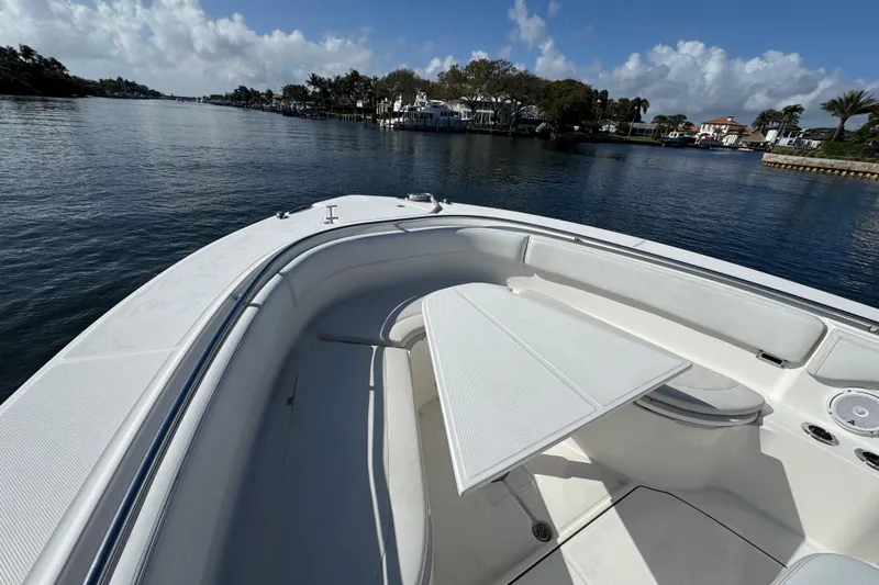  Yacht Photos Pics 2017 Edgewater 368CC boat with seating area and table on calm water.
