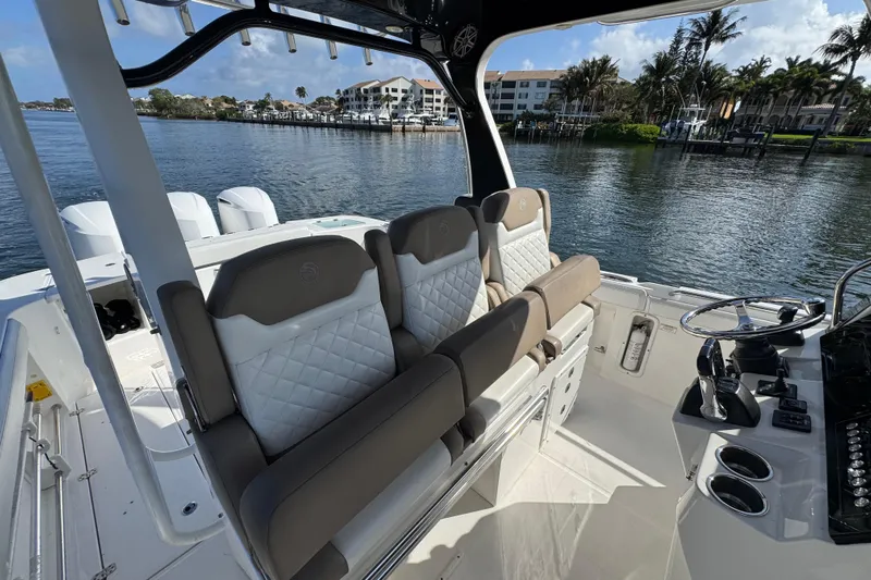  Yacht Photos Pics 2017 Edgewater 368CC boat interior with luxurious seating and steering console by the water.