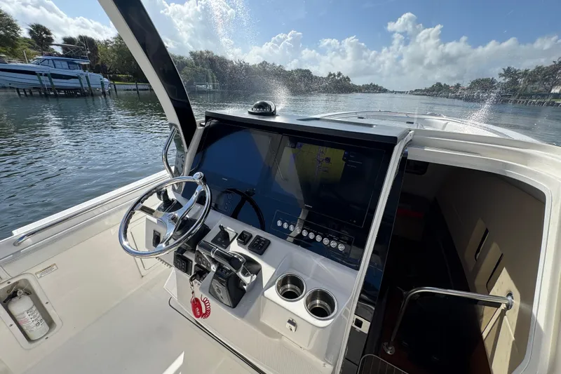  Yacht Photos Pics Edgewater 368CC 2017 boat helm with steering wheel and navigation display.