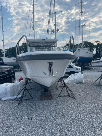 Ann #121 Yacht Photos Pics 2023 Nimbus T9 #121 Twin Engine boat on a gravel lot with other boats.