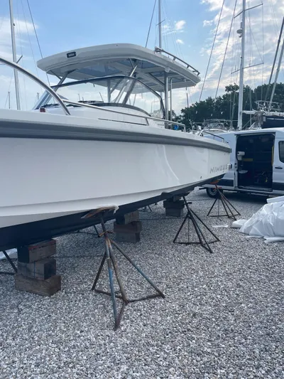 Ann #121 Yacht Photos Pics 2023 Nimbus T9 #121 Twin Engine boat on stands in a marina.