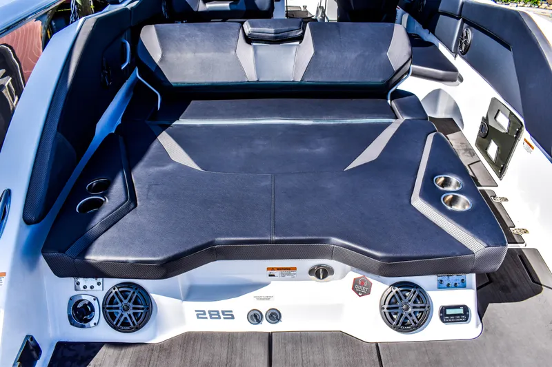  Yacht Photos Pics 2024 Scarab 285 ID boat interior with cushioned seating, cup holders, and audio speakers.