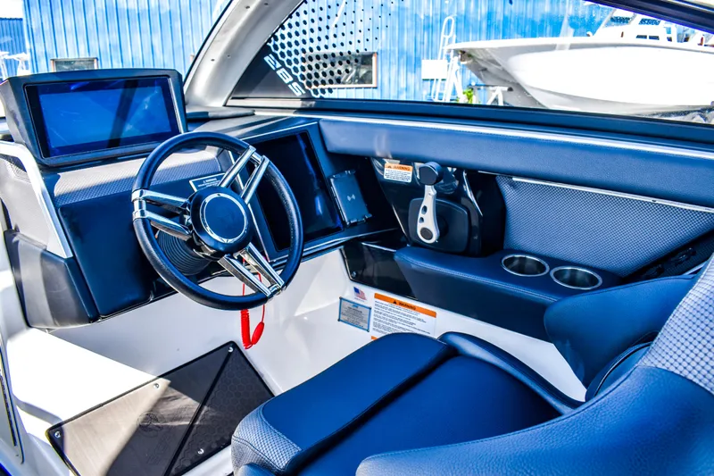  Yacht Photos Pics 2024 Scarab 285 ID boat interior with modern steering and dashboard controls.