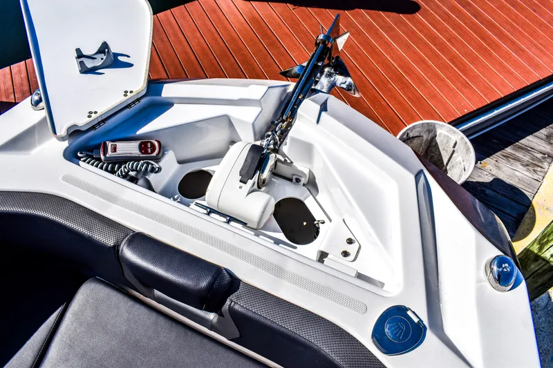  Yacht Photos Pics 2024 Scarab 285 ID boat anchor compartment with control panel and seating.