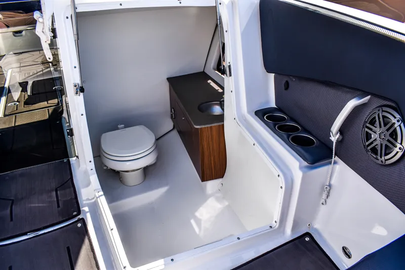  Yacht Photos Pics 2024 Scarab 285 ID boat interior with toilet, sink, and cup holders.