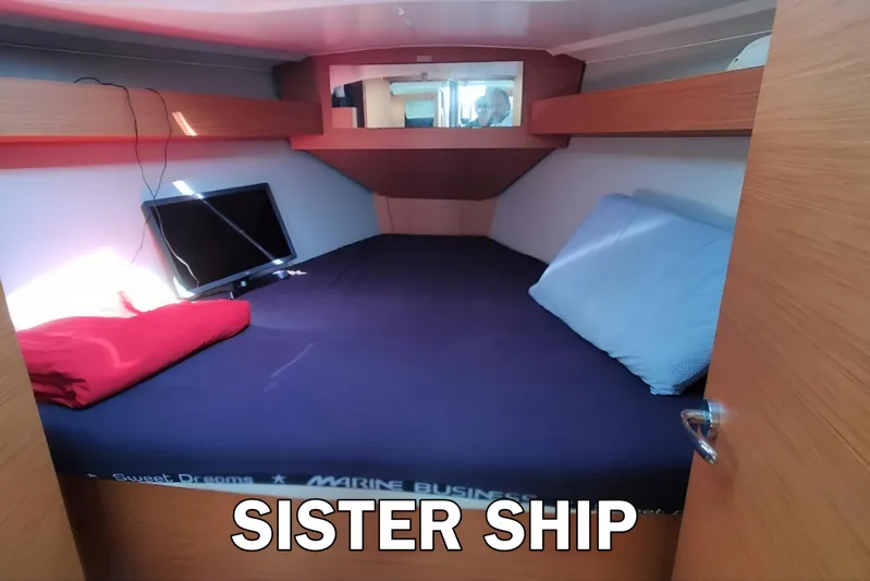  Yacht Photos Pics Cozy cabin interior of 2020 Dufour 360 Grand Large yacht with bed and TV.