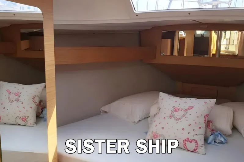  Yacht Photos Pics Cozy cabin interior of 2020 Dufour 360 Grand Large sailboat with decorative pillows.