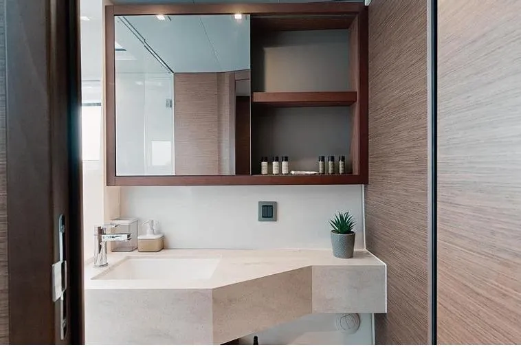  Yacht Photos Pics Modern bathroom interior on 2020 Lagoon 46 yacht, featuring sleek sink and wooden cabinetry.
