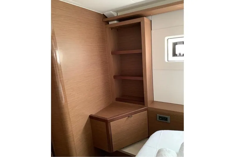  Yacht Photos Pics Interior of 2020 Lagoon 46 yacht with wooden shelves and window.