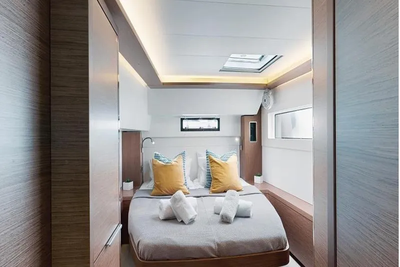  Yacht Photos Pics Luxurious cabin interior of 2020 Lagoon 46 yacht with modern design and cozy bedding.