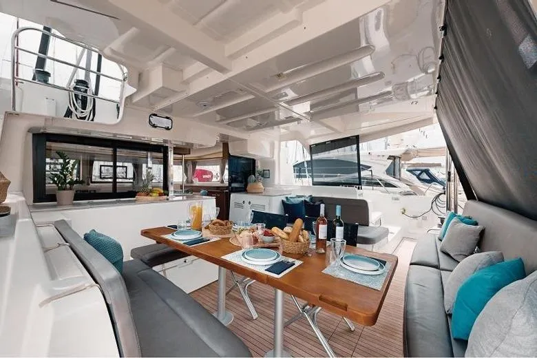  Yacht Photos Pics Luxurious Lagoon 46 catamaran interior with elegant dining setup, 2020 model.