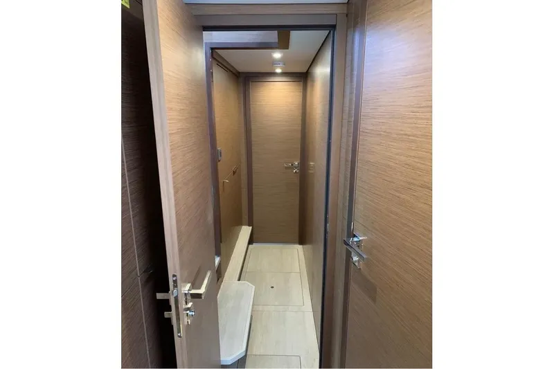  Yacht Photos Pics Interior hallway of 2020 Lagoon 46 yacht with wooden doors and modern design.