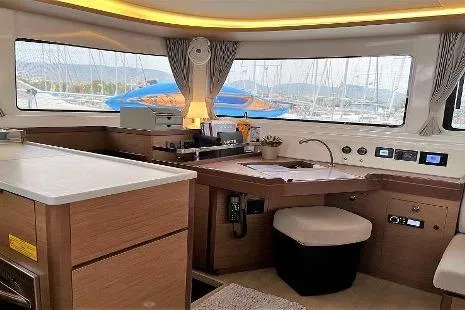  Yacht Photos Pics Interior of 2020 Lagoon 46 yacht with modern navigation station and panoramic windows.