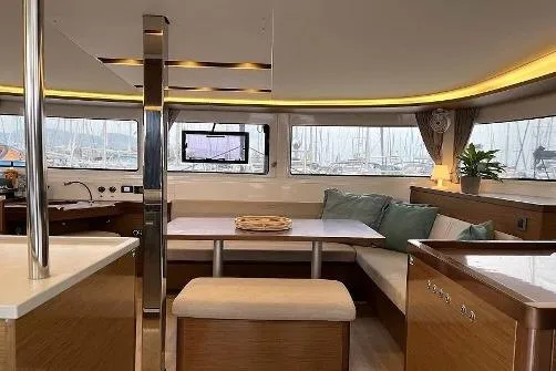  Yacht Photos Pics Interior of 2020 Lagoon 46 yacht with modern seating and panoramic windows.