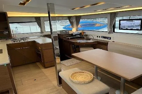  Yacht Photos Pics Interior of 2020 Lagoon 46 catamaran with modern kitchen and dining area.