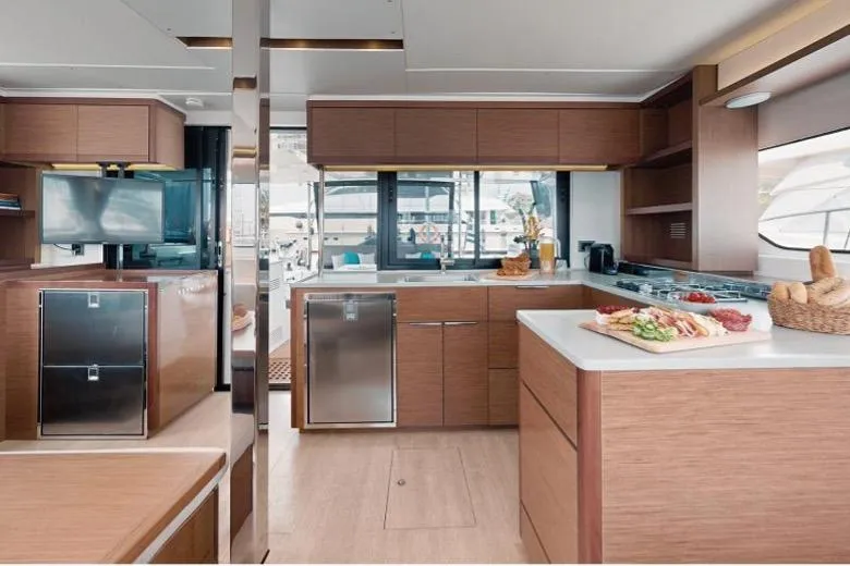  Yacht Photos Pics Luxurious 2020 Lagoon 46 yacht interior with modern kitchen and elegant wood finishes.