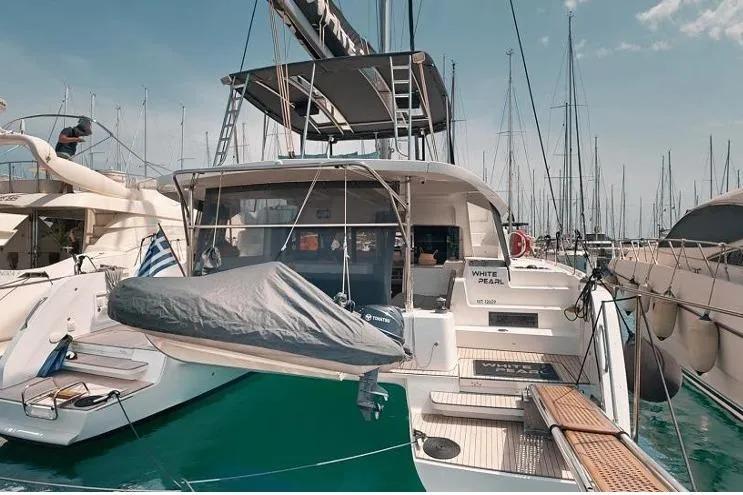  Yacht Photos Pics 2020 Lagoon 46 catamaran docked at marina, featuring spacious deck and modern design.