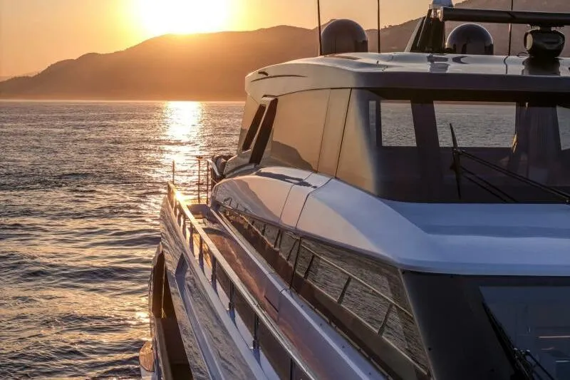  Yacht Photos Pics Ferretti Yachts 1000 SKYDECK 2022 cruising at sunset with scenic mountain backdrop.