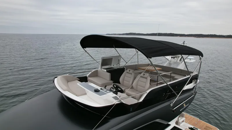  Yacht Photos Pics 2024 Fairline Squadron 50 luxury yacht with spacious deck and canopy on calm waters.