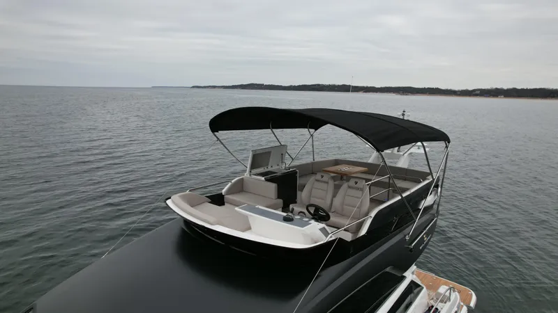  Yacht Photos Pics 2024 Fairline Squadron 50 luxury yacht with spacious deck and canopy on calm waters.