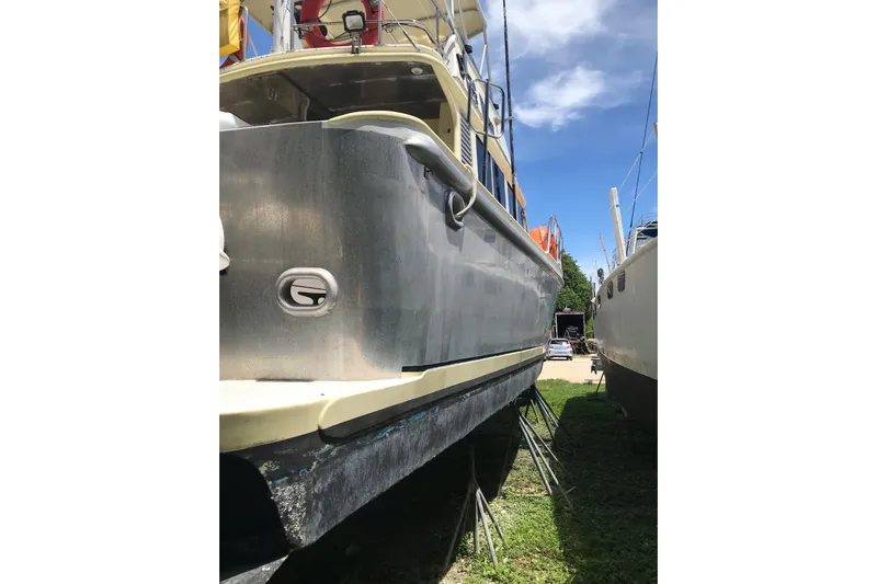 Tuff Baby Yacht Photos Pics 1999 Custom Sport Fishing boat on land, blue sky background.