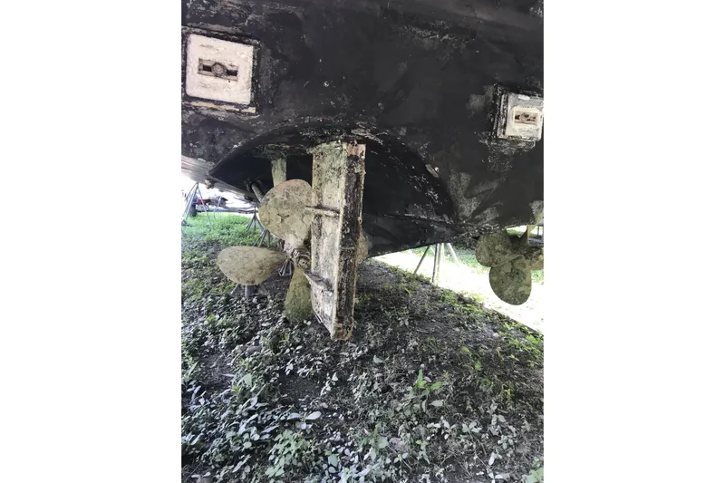 Tuff Baby Yacht Photos Pics Underside of a 1999 Custom Sport Fishing boat with visible propellers and rudder.