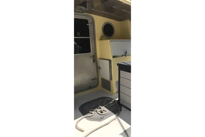 Tuff Baby Yacht Photos Pics 1999 Custom Sport Fishing boat interior with rope and storage compartments.