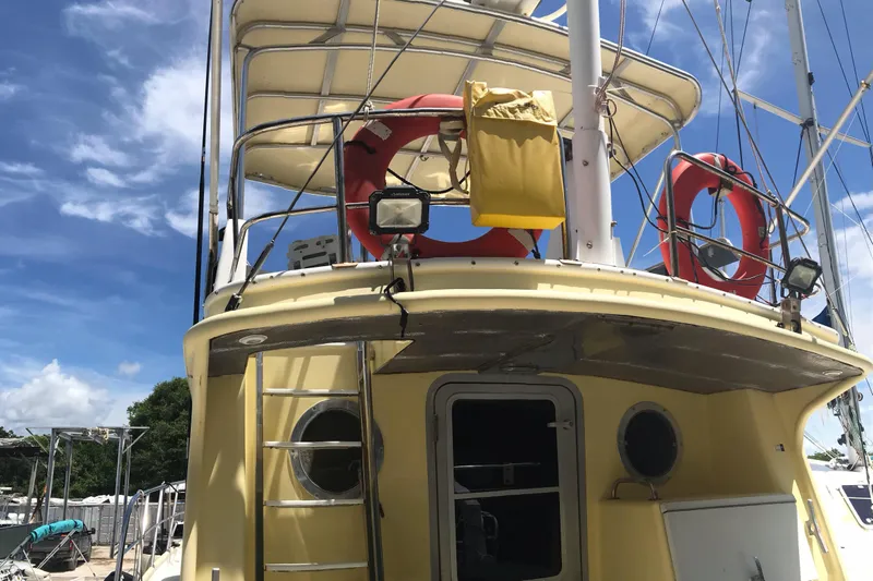 Tuff Baby Yacht Photos Pics 1999 Custom Sport Fishing boat with life rings and ladder under a clear sky.